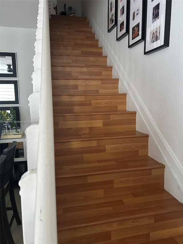 stairway with hardwood / wood-style flooring