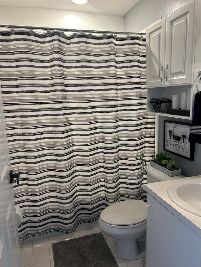 bathroom with toilet, a shower with curtain, vanity, and tile patterned floors