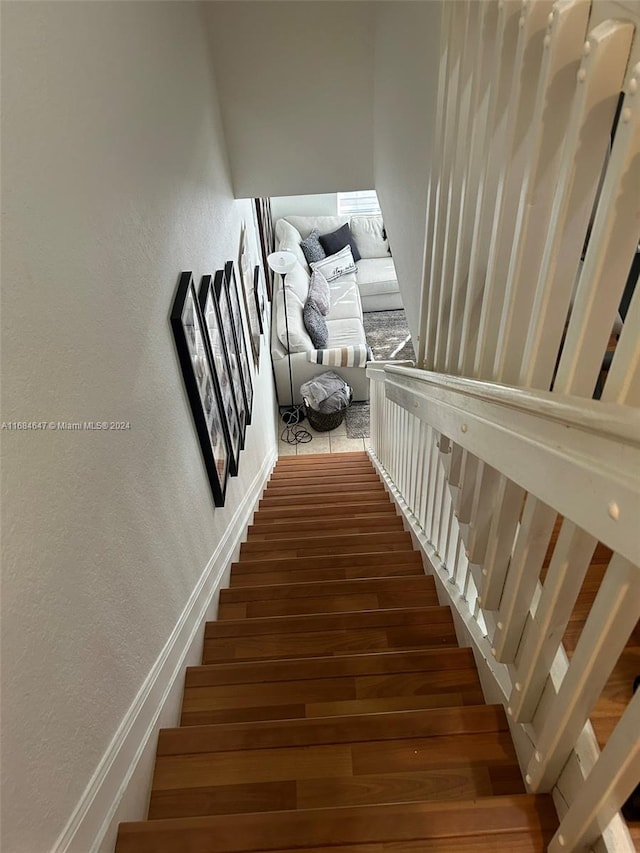 staircase with hardwood / wood-style flooring