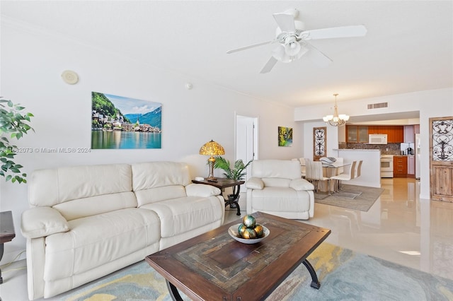 living room featuring crown molding and ceiling fan with notable chandelier