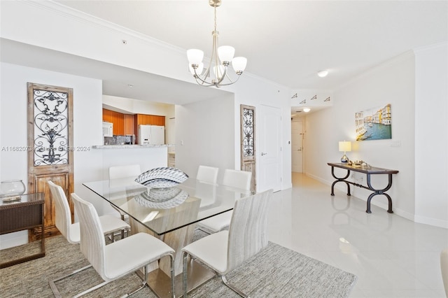 16699 Collins Ave Unit 2202, Sunny Isles Beach, FL 33160 - dining area featuring ornamental molding, a chandelier, baseboards, and light tile patterned floors