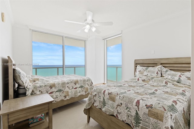 bedroom with crown molding, a water view, and ceiling fan