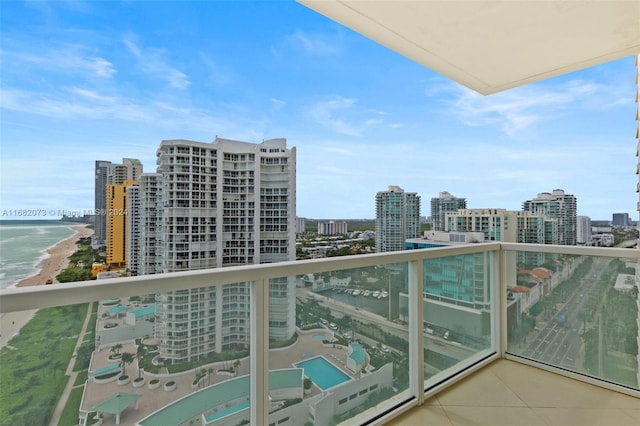 balcony with a water view and a beach view