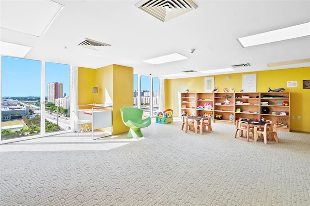 16699 Collins Ave Unit 2202, Sunny Isles Beach, FL 33160 - recreation room featuring carpet, floor to ceiling windows, baseboards, and a skylight