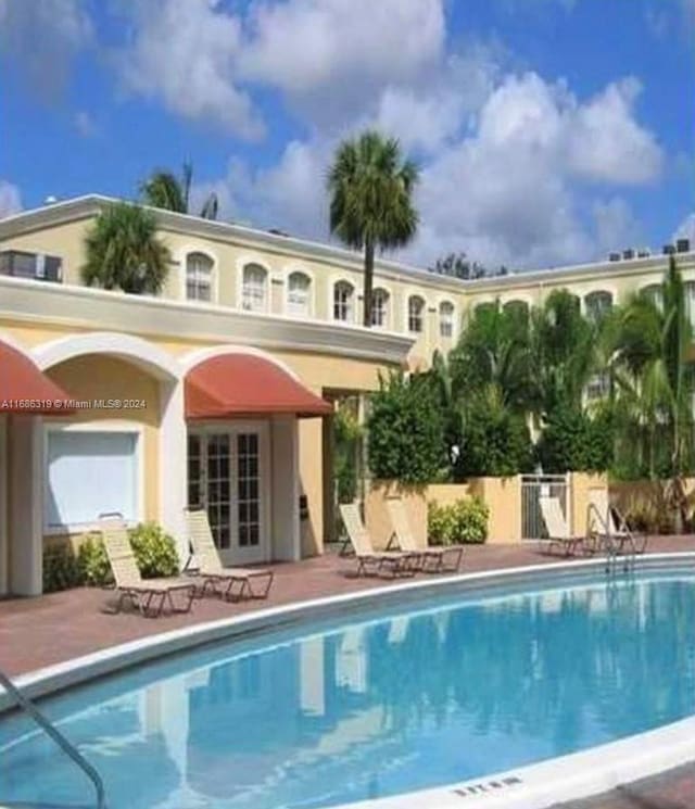 view of swimming pool with a patio area