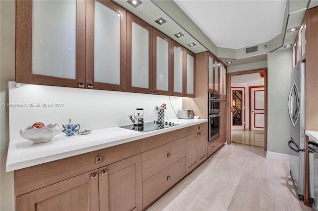 kitchen with appliances with stainless steel finishes and light wood-type flooring