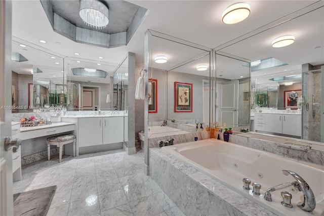 bathroom with vanity, independent shower and bath, and an inviting chandelier