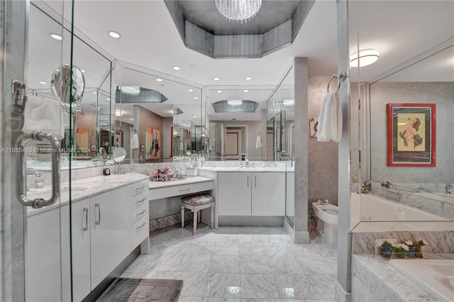 bathroom featuring vanity, a relaxing tiled tub, a bidet, and a raised ceiling