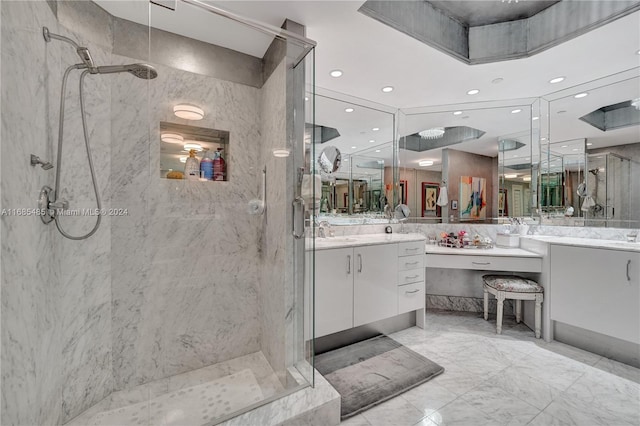 bathroom featuring a shower with door and vanity