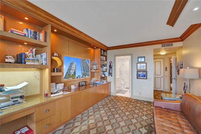 carpeted office featuring built in desk and ornamental molding