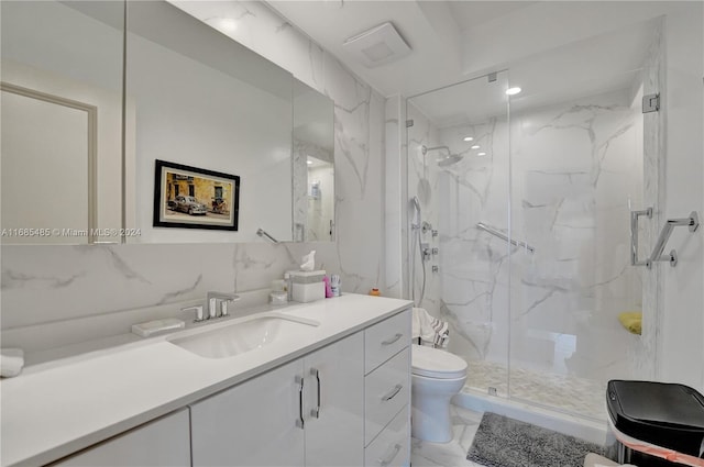 bathroom featuring tasteful backsplash, tile walls, toilet, a shower with shower door, and vanity