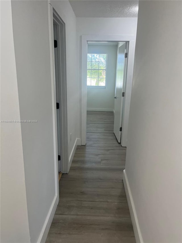 corridor featuring wood-type flooring