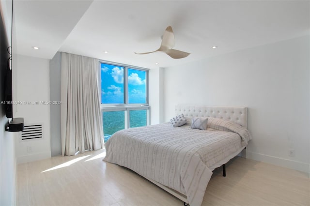 bedroom with ceiling fan and light wood-type flooring