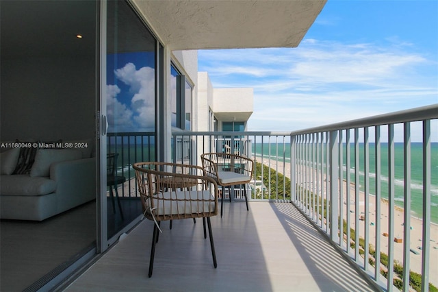 balcony with a water view and a beach view