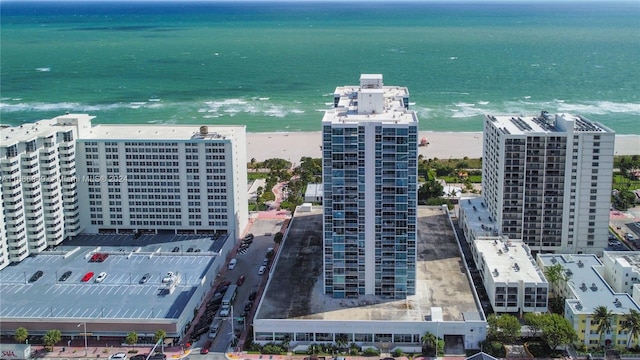 bird's eye view featuring a water view and a beach view