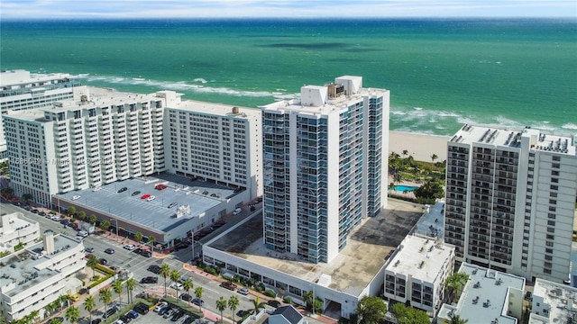 bird's eye view with a water view and a beach view