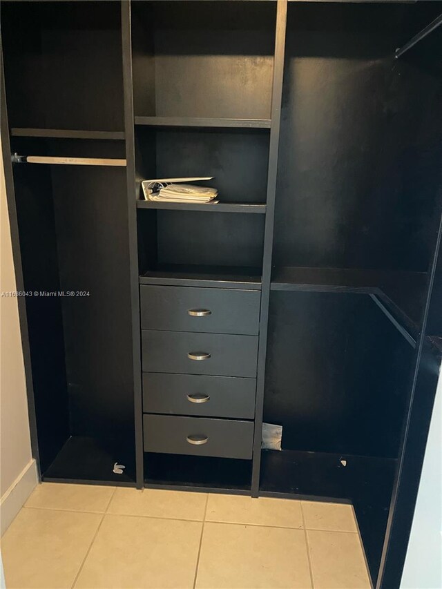 walk in closet with tile patterned floors