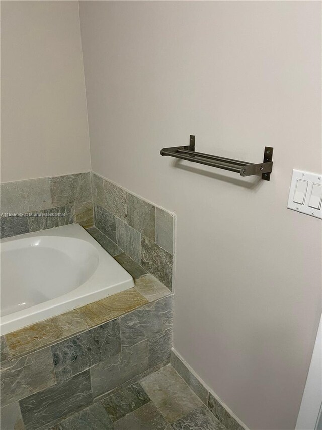 2641 N Flamingo Rd Unit 802N, Sunrise, FL 33323 - full bathroom with a garden tub, stone finish flooring, and baseboards