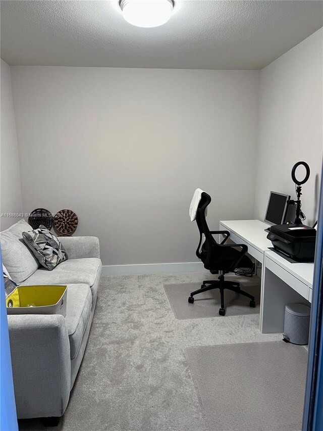 office area with a textured ceiling and carpet floors