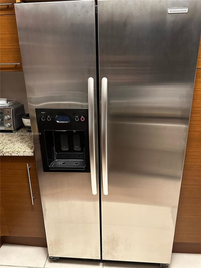 2641 N Flamingo Rd Unit 802N, Sunrise, FL 33323 - kitchen view of stainless steel refrigerator with ice dispenser, light stone countertops, brown cabinets, and modern cabinets