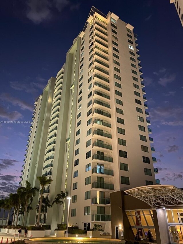 view of outdoor building at dusk