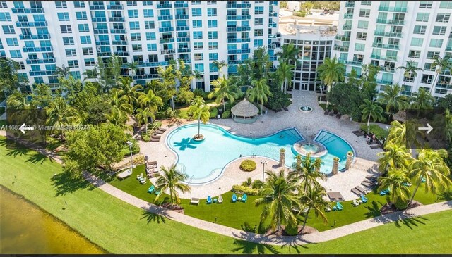 view of pool with a patio and a yard