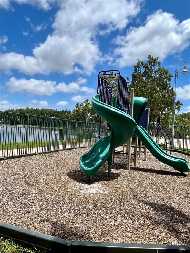 view of playground with a water view