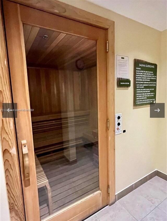 view of sauna / steam room with wood ceiling and tile patterned flooring