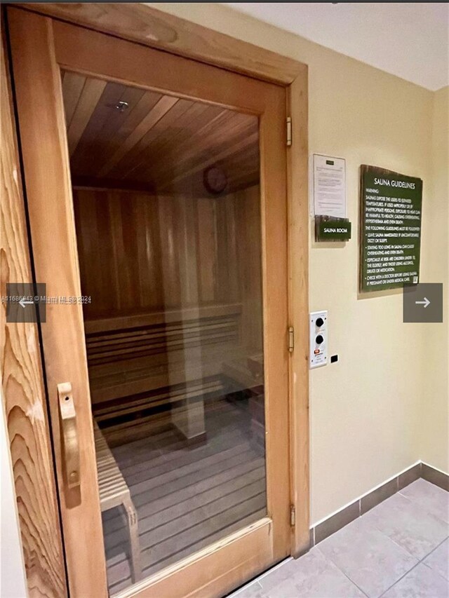 view of sauna with wood ceiling and tile patterned flooring