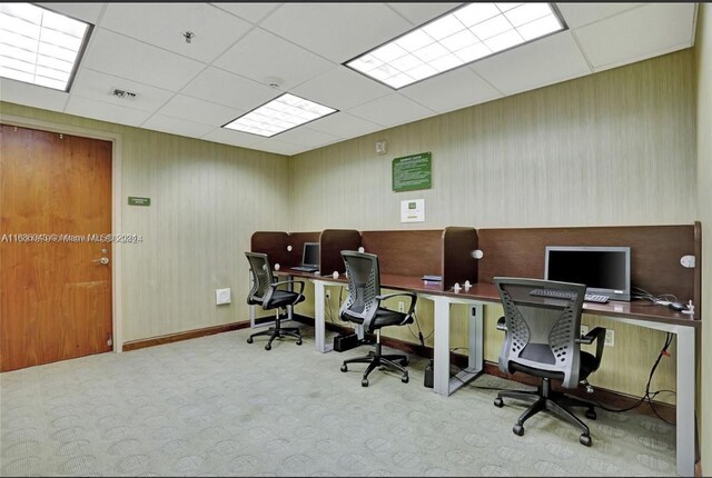 carpeted office with a drop ceiling