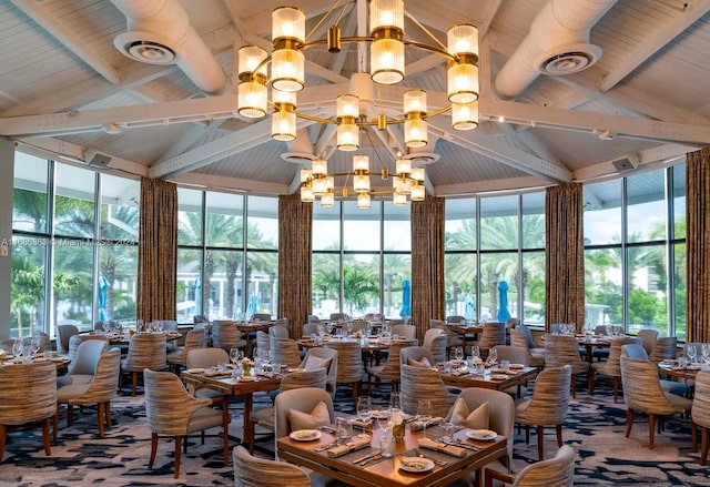 dining room with beam ceiling, a notable chandelier, high vaulted ceiling, and wood ceiling