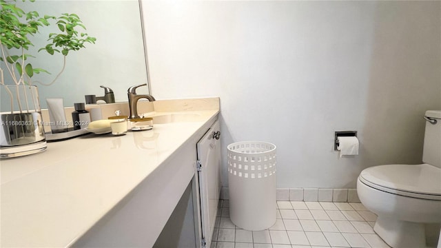 bathroom featuring vanity, toilet, and tile patterned flooring