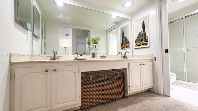 bathroom with toilet, an enclosed shower, and vanity