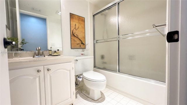 full bathroom with vanity, enclosed tub / shower combo, toilet, and tile patterned floors