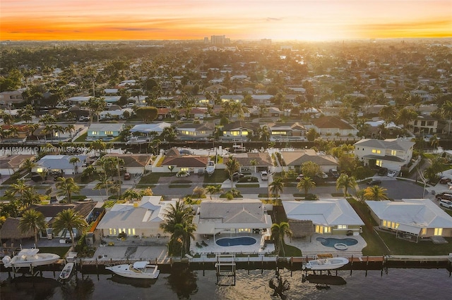 aerial view at dusk with a water view