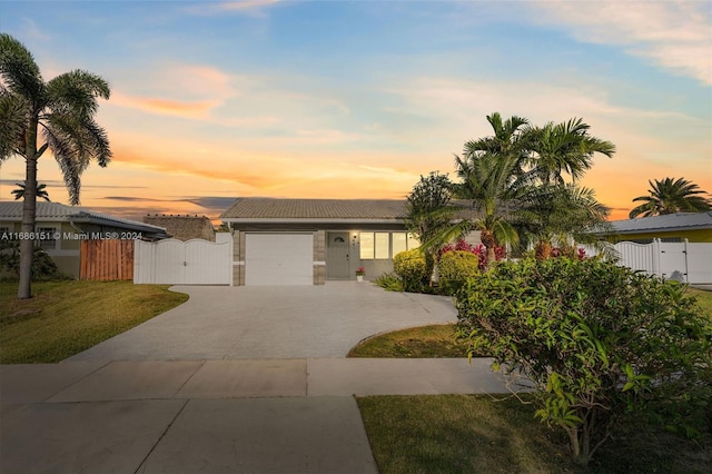 view of front of property with a garage and a lawn