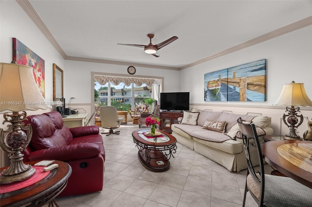 tiled living room with ceiling fan and ornamental molding