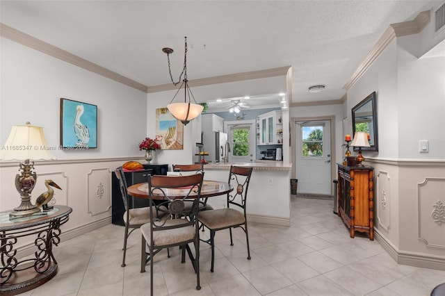 dining space featuring crown molding, a textured ceiling, and light tile patterned flooring