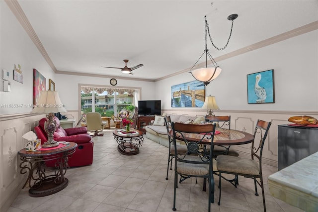 dining area featuring ceiling fan, crown molding, and light tile patterned floors