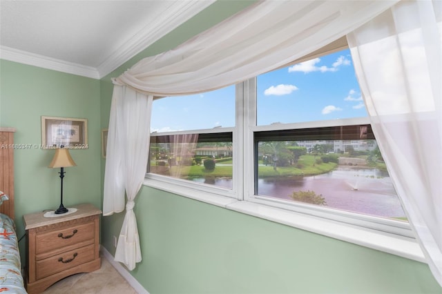 bedroom with a water view and crown molding