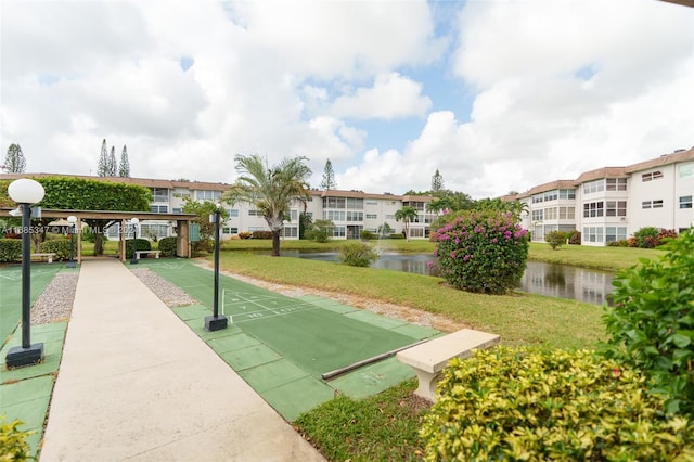 surrounding community featuring a yard and a water view