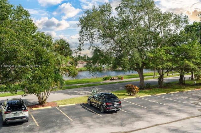 view of car parking with a water view