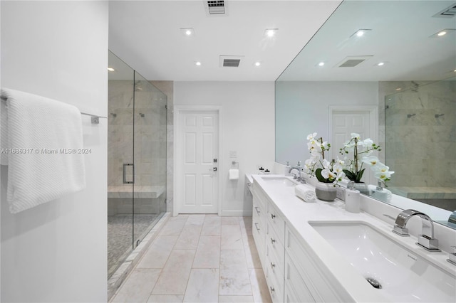 bathroom featuring vanity and a shower with shower door