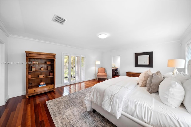 bedroom featuring dark wood-type flooring and ornamental molding