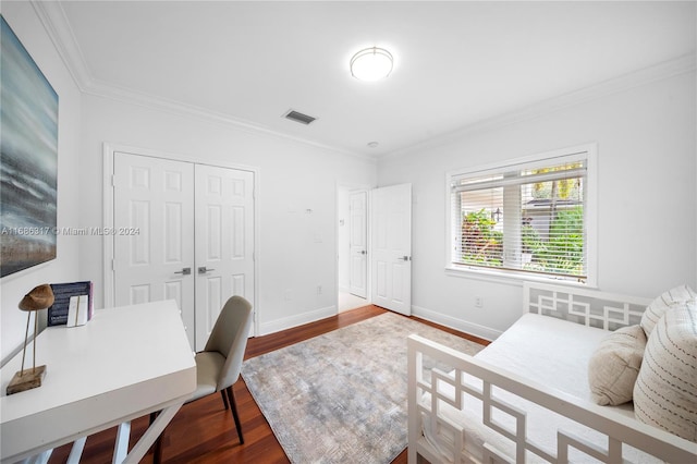 bedroom featuring hardwood / wood-style flooring, a closet, and crown molding