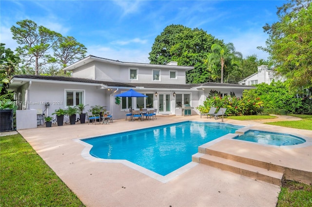 view of pool with an in ground hot tub, french doors, and a patio