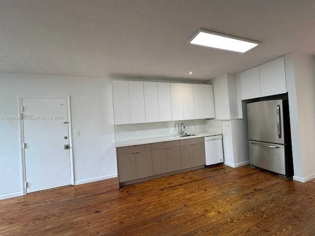 kitchen featuring white cabinets, stainless steel refrigerator, dishwasher, dark hardwood / wood-style floors, and sink