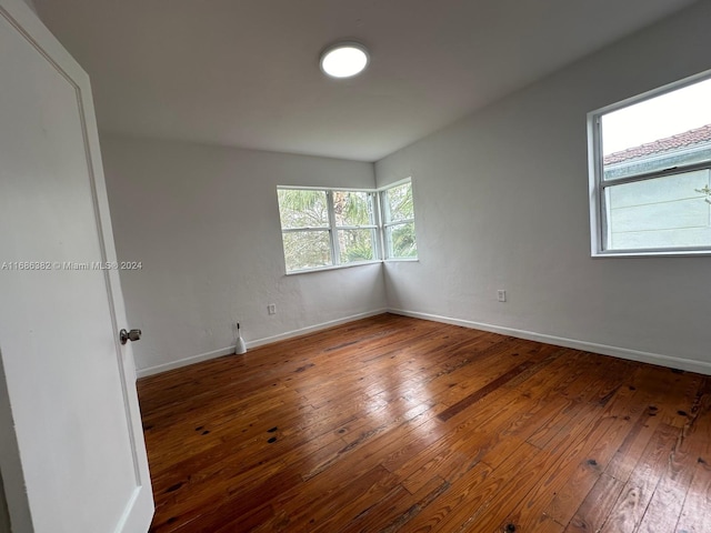 unfurnished room with wood-type flooring