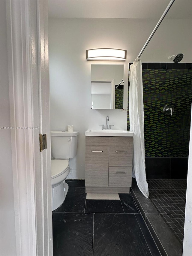 bathroom featuring vanity, toilet, a shower with curtain, and tile patterned flooring