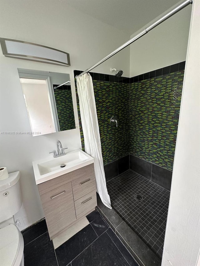 bathroom with vanity, toilet, curtained shower, and tile patterned flooring